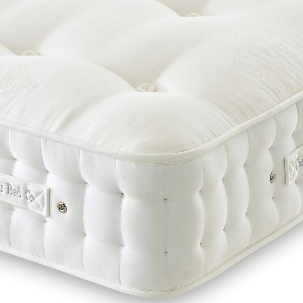 White mattress with visible branding on a light background