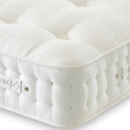 White mattress with visible branding on a light background