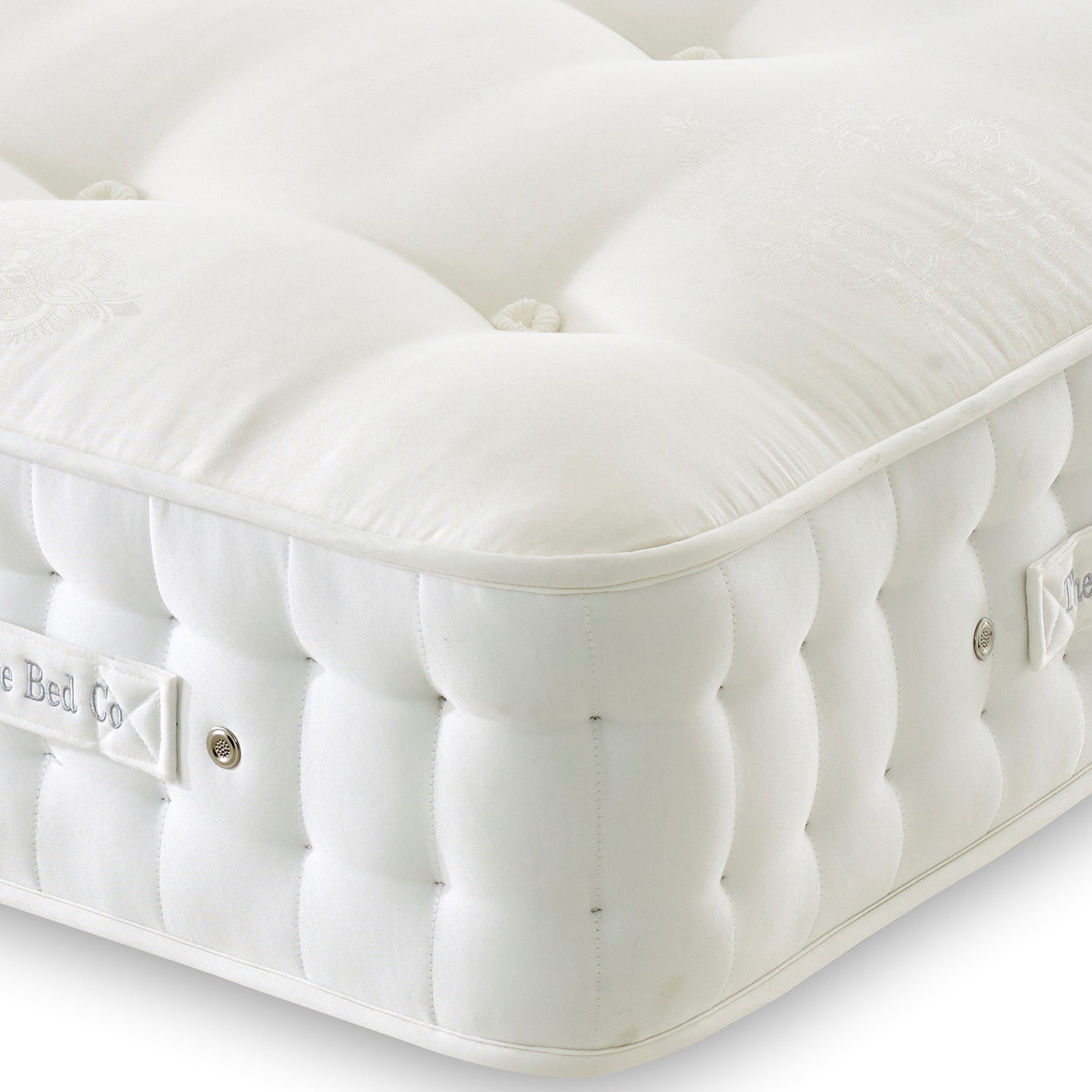White mattress with visible branding on a light background