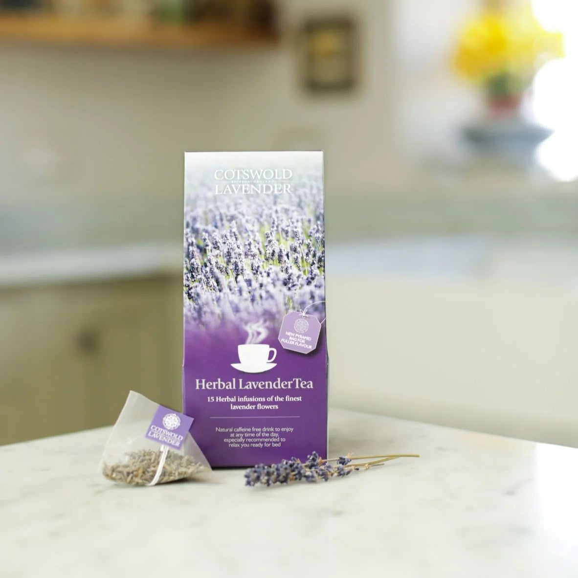 Herbal lavender tea package on a white surface with a blurred kitchen background
