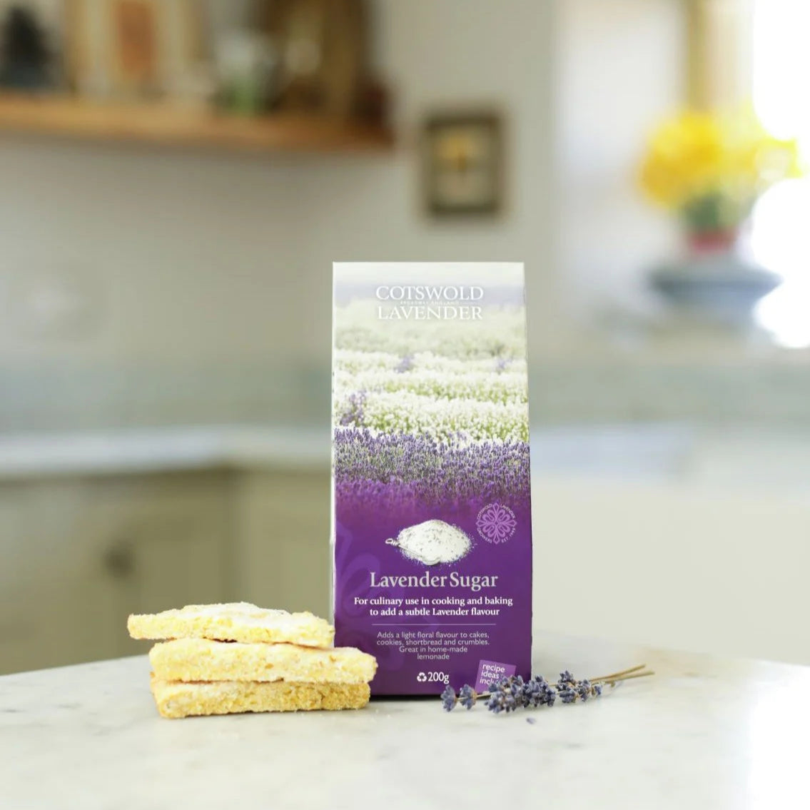 Gotskold Lavender lavender sugar package on a kitchen counter with cookies and lavender flowers.