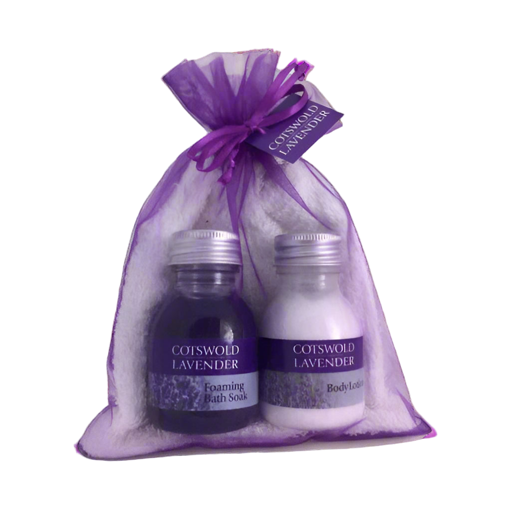 Cotswold Lavender bath and body products in a purple gift bag on a white background